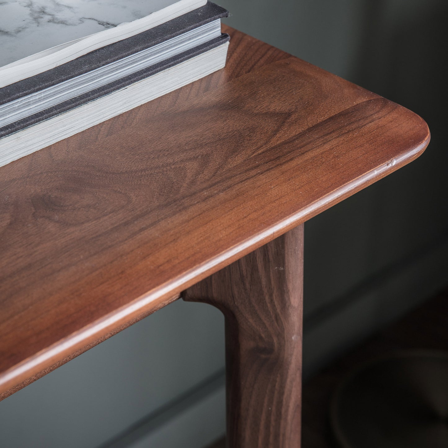 A Walnut home furniture piece, the Dairy 1 Drawer Desk by Kikiathome.co.uk, adorned with a book for interior decor.