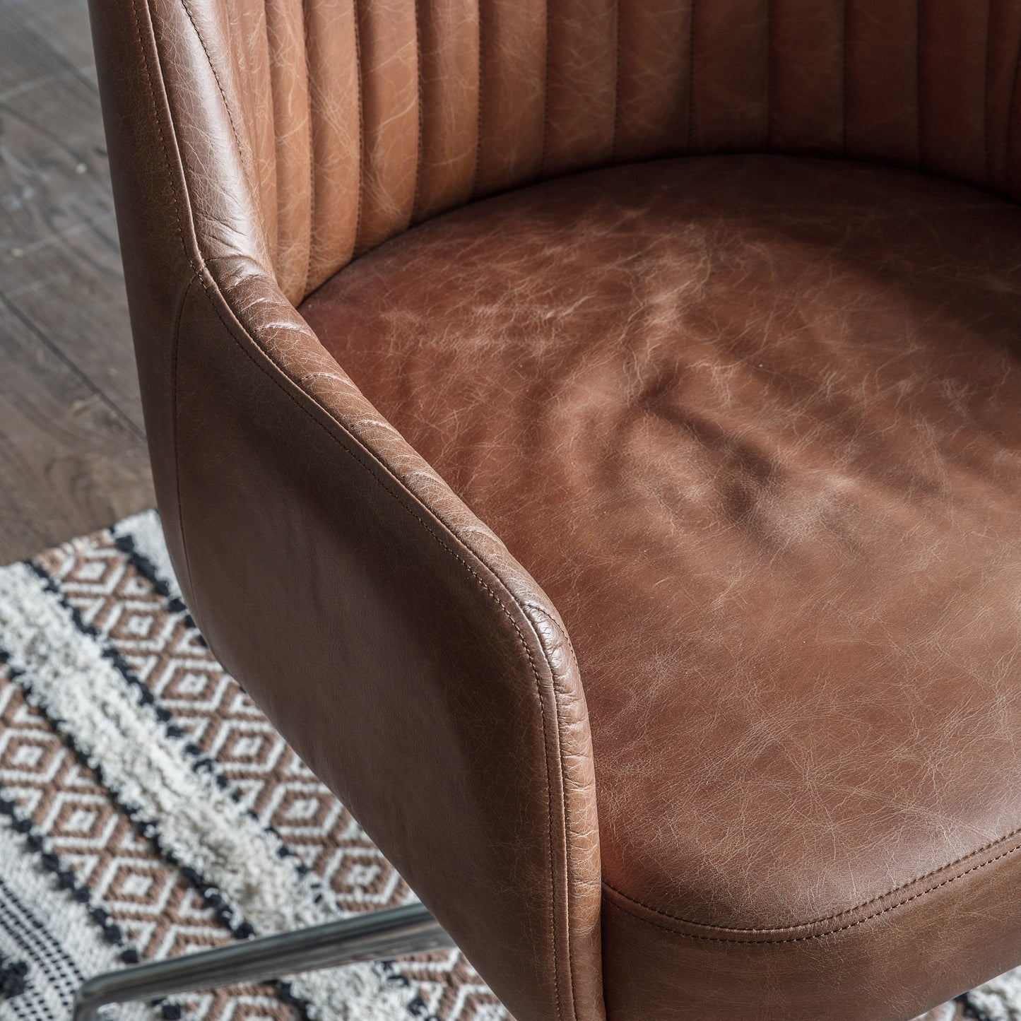 A vintage brown leather Curie Swivel Chair for home furniture and interior decor.