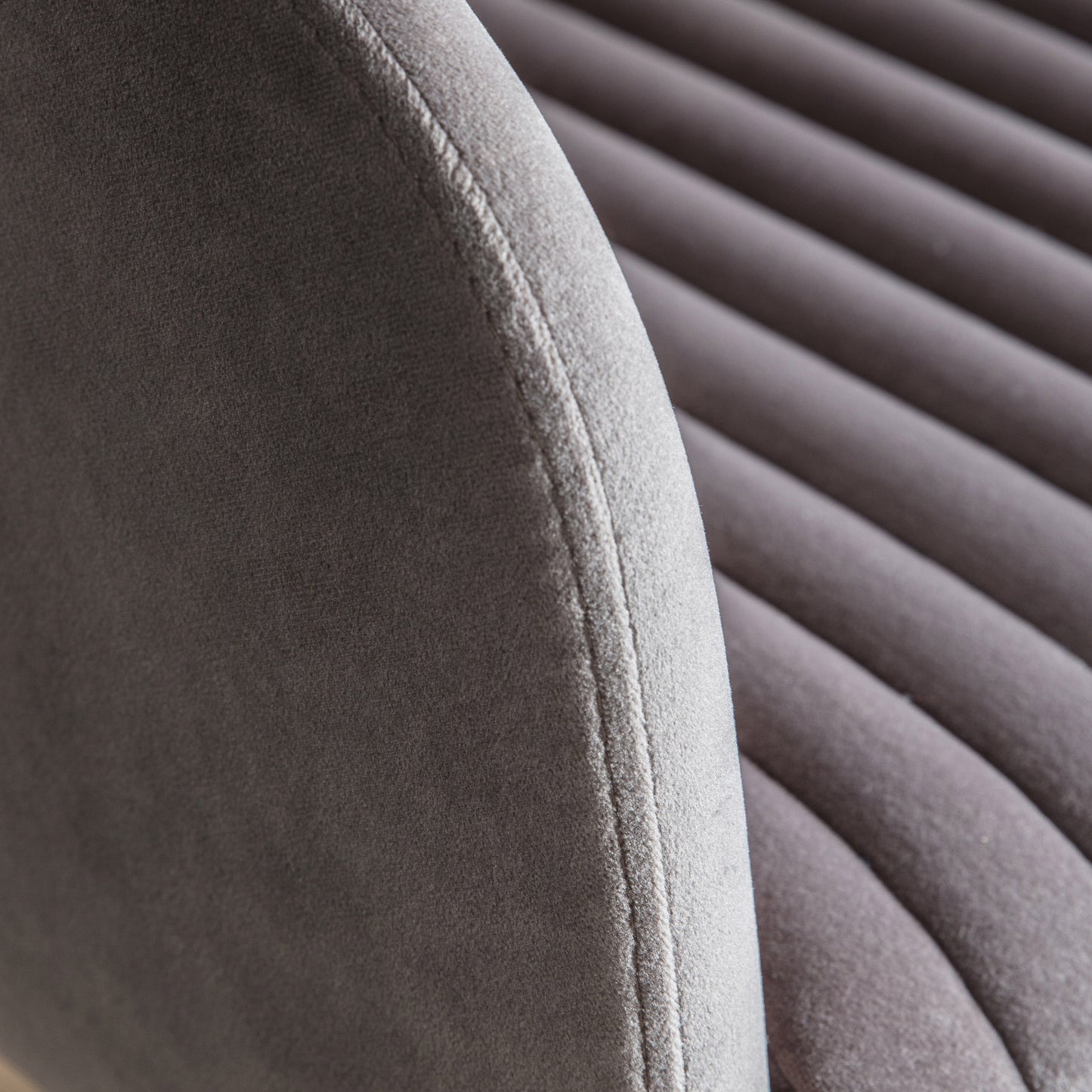 A close up of the back of a Murray Swivel Chair Grey Velvet for home furniture or interior decor.