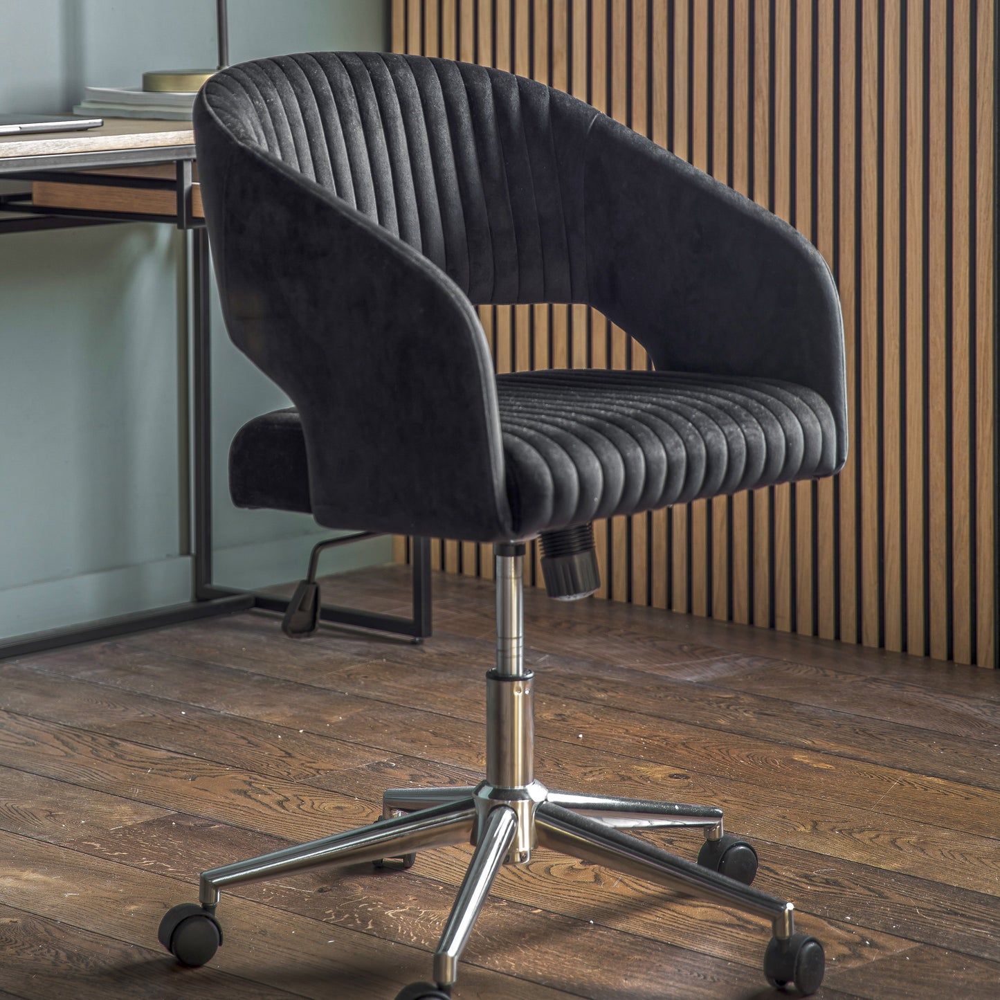 A black velvet swivel chair on casters from Kikiathome.co.uk, perfect for interior decor.