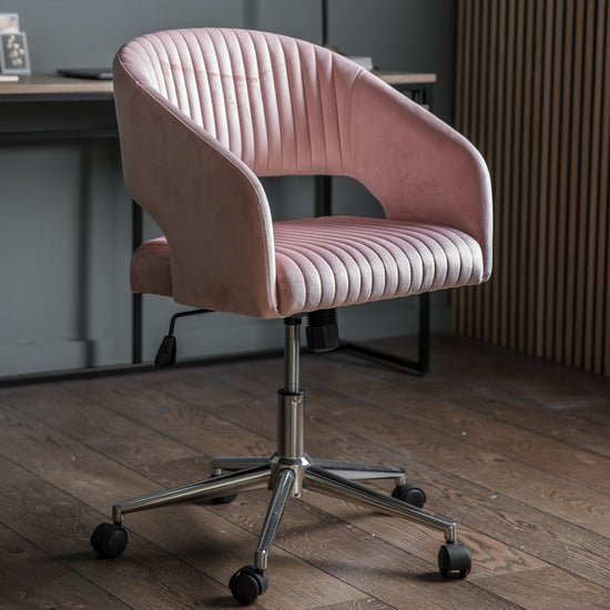 A Murray Swivel Chair Pink Velvet in a stylish interior decor.