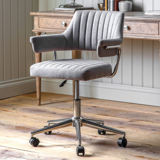 A Grey Swivel Chair by Kikiathome.co.uk with wheels for home furniture and interior decor.