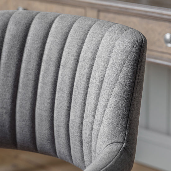 A Mcintyre Swivel Chair Grey with a wooden base for home furniture and interior decor from Kikiathome.co.uk.