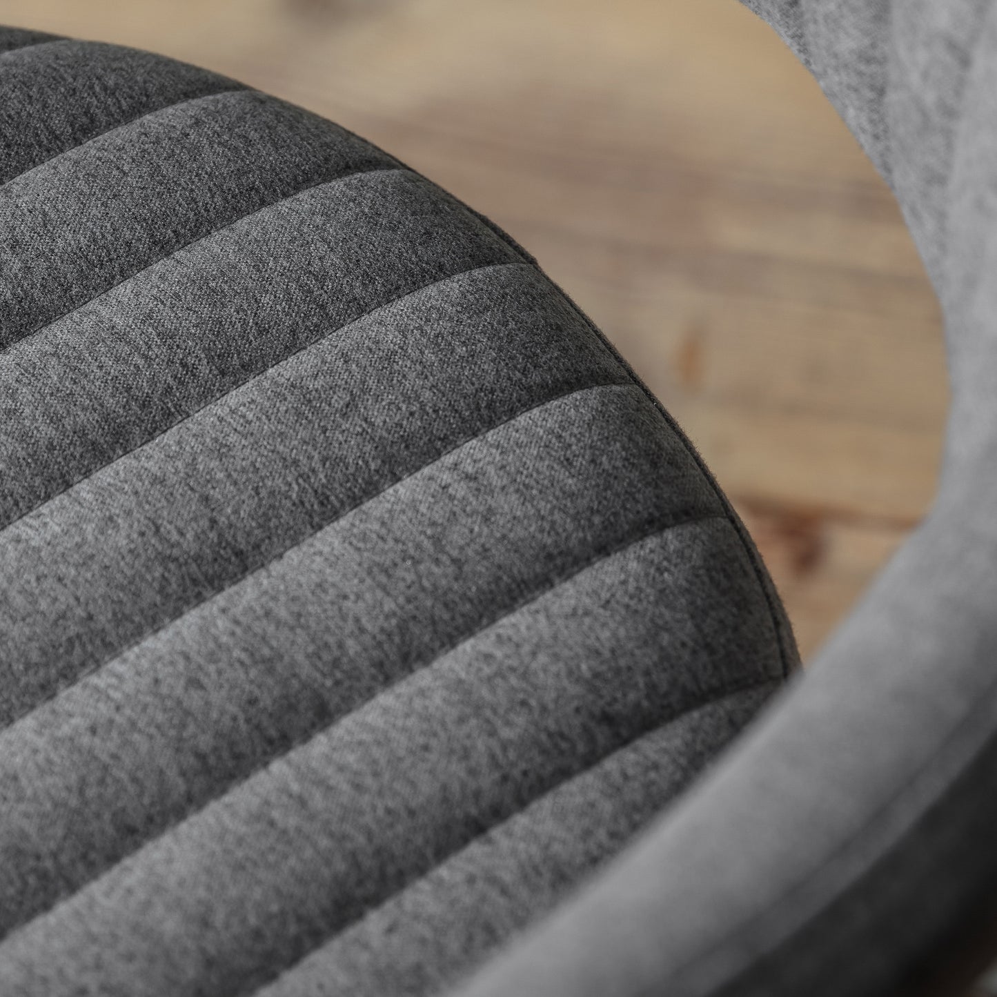 A close up of the Kikiathome.co.uk McIntyre Swivel Chair in Charcoal for interior decor.