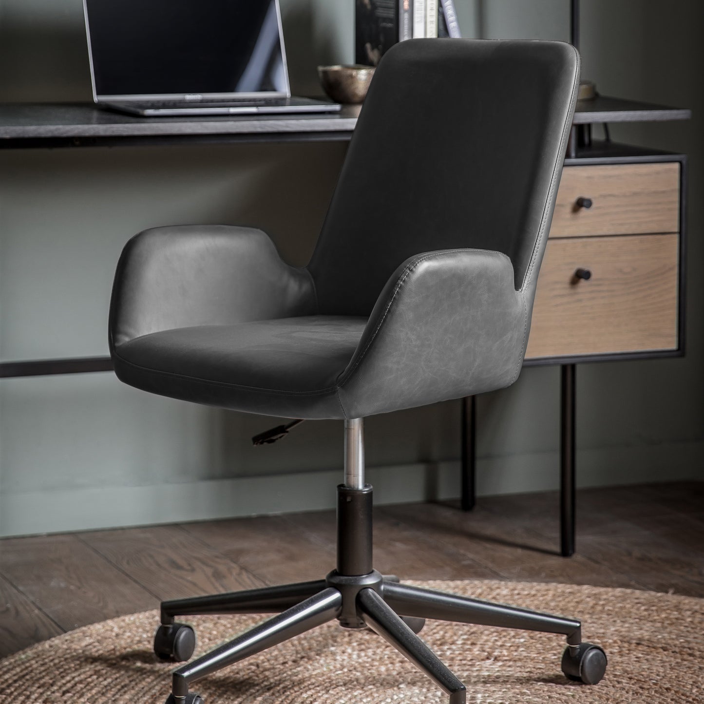 Load image into Gallery viewer, A charcoal Noss Swivel Chair with a black leather seat for interior decor by Kikiathome.co.uk.
