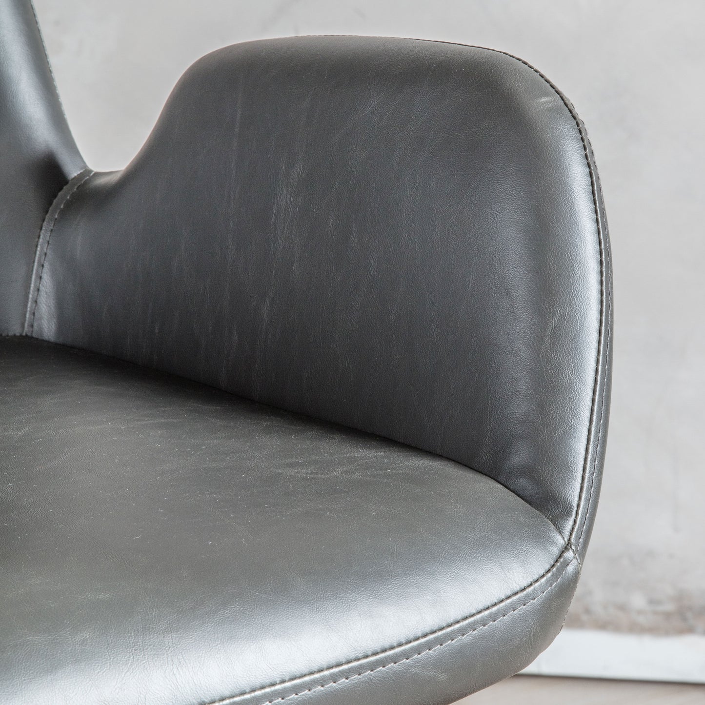 A close up of a Noss Swivel Chair Charcoal for interior decor.