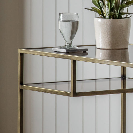 An Engleborne Desk Bronze 1300x500x760mm from Kikiathome.co.uk adorned with a plant, perfect for interior decor.