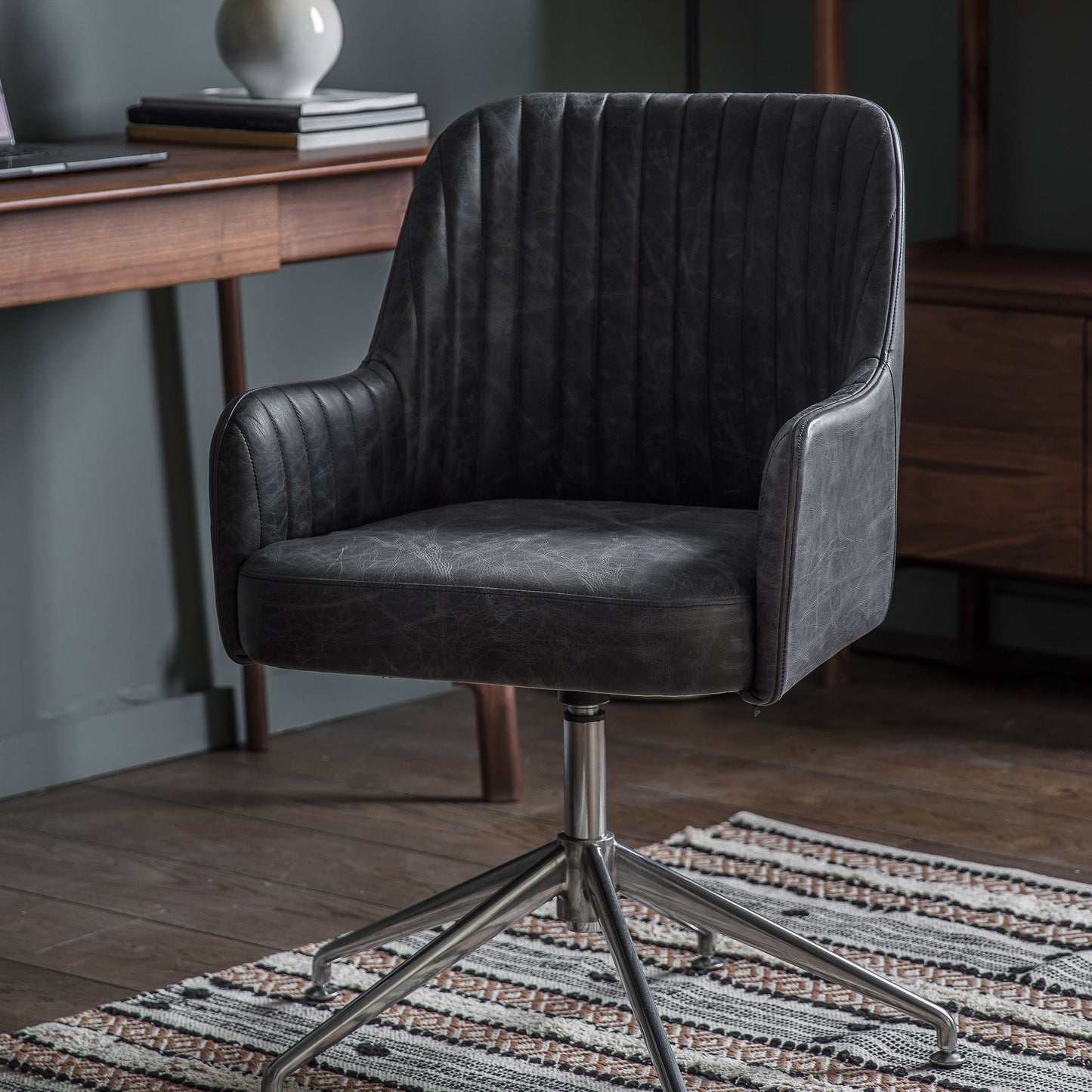 A Curie Swivel Chair in Antique Ebony, a stylish addition to any home interior decor.