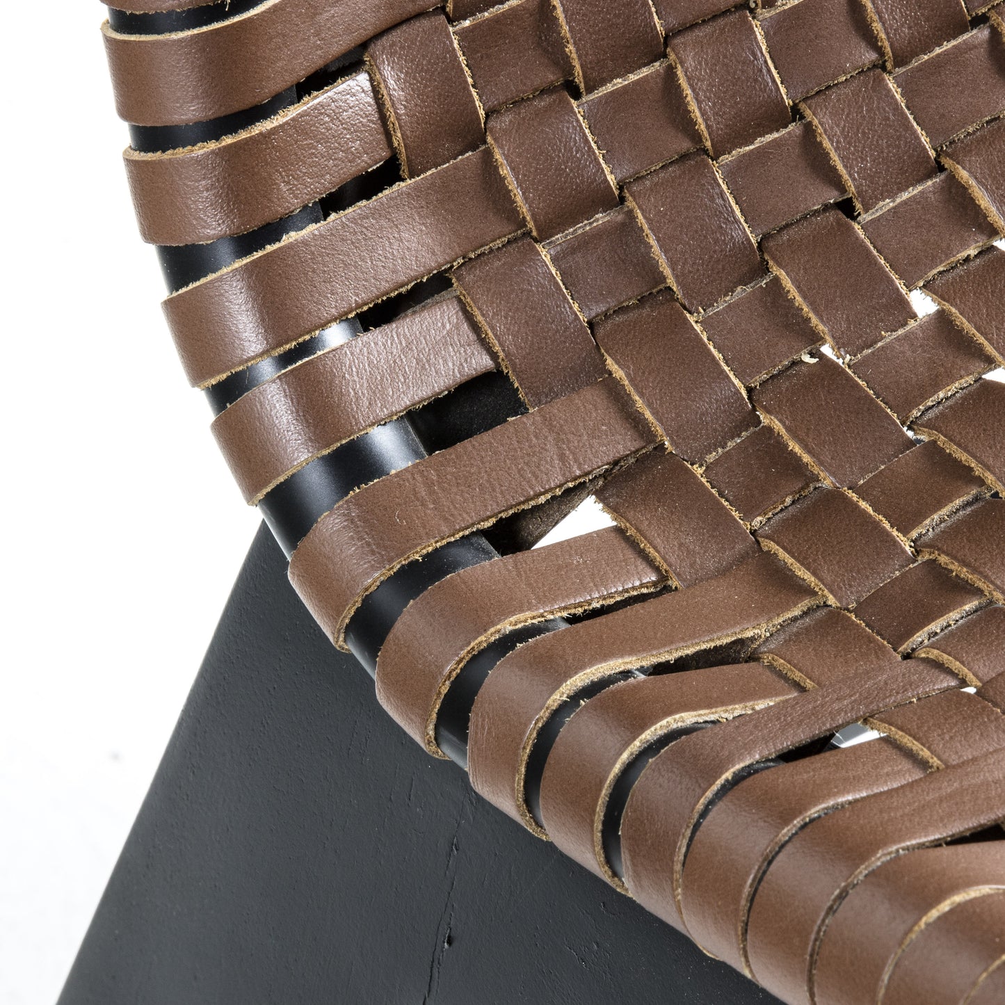 A close up of a Seville Lounge Chair Brown Leather woven chair, perfect for interior decor and home furniture.