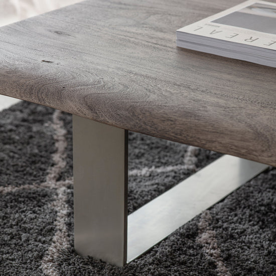 A Southpool Coffee Table with a metal base and a book on it, perfect for interior decor and home furniture.