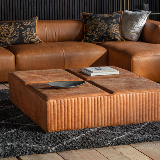 A 1200x1200x300mm coffee table in brown leather from Kikiathome.co.uk adds a touch of interior decor to the living room.