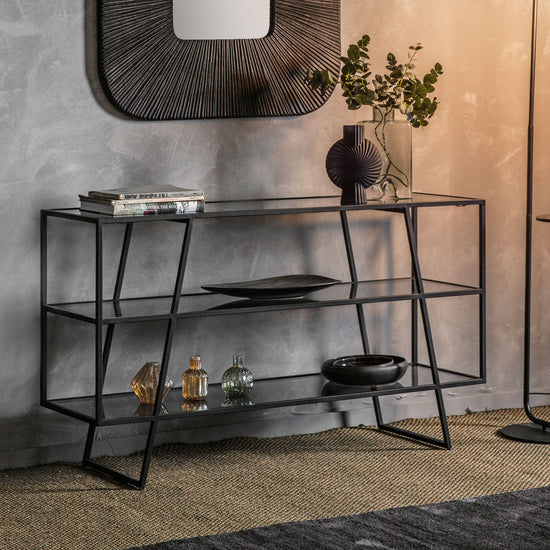 A black Putney Console Table 1400x405x800mm from Kikiathome.co.uk with a mirror and vase, perfect for interior decor and home furniture.