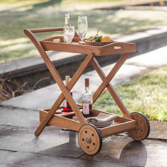An outdoor drinks trolley with a bottle of wine, perfect for your home's interior decor.