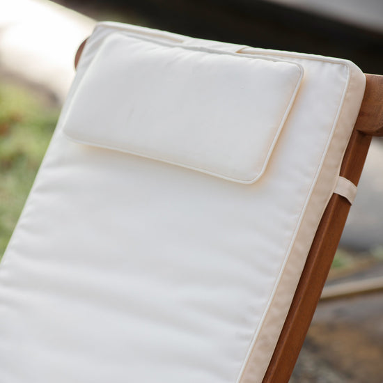 Load image into Gallery viewer, A Bickington Outdoor Lounger with a white cushion perfect for interior decor.
