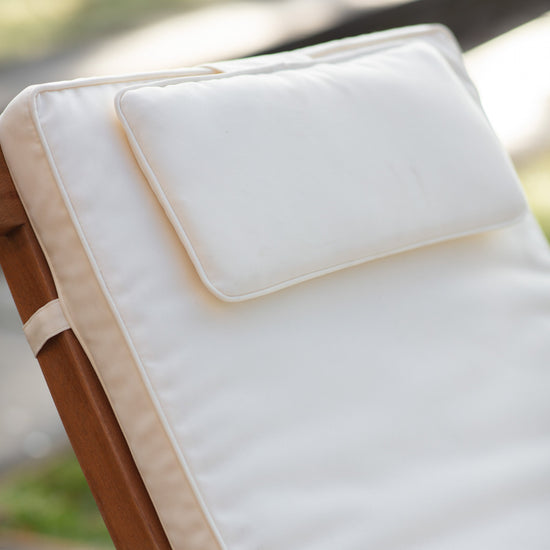 Load image into Gallery viewer, A Bickington Outdoor Lounger on a wooden chair for stylish home furniture from Kikiathome.co.uk.
