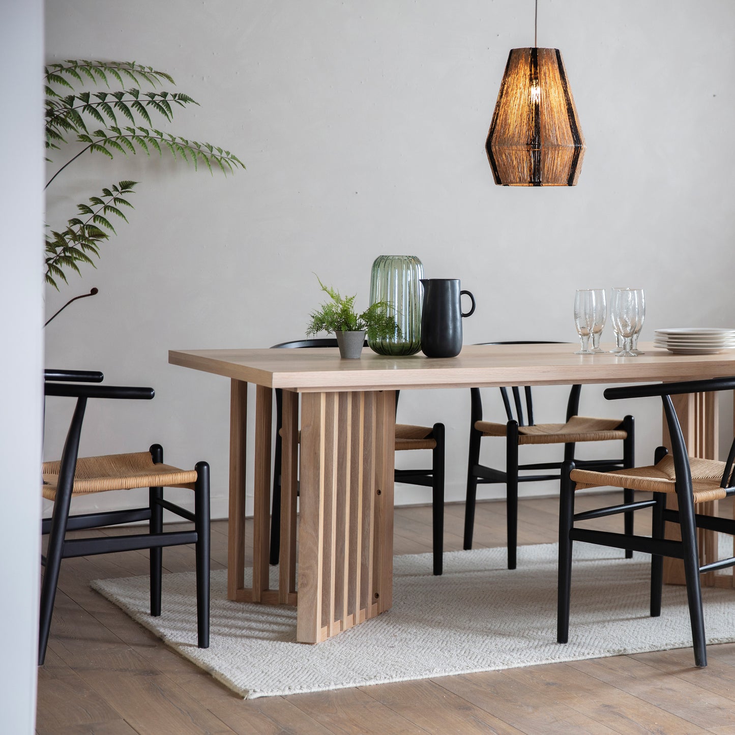 A dining room with stylish interior decor featuring a Tortington Dining Table and chairs from Kikiathome.co.uk.