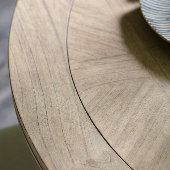 A close up of a Belsford Round Dining Table 1100x1100x750mm from Kikiathome.co.uk with a plate on it, perfect for home furniture and interior decor