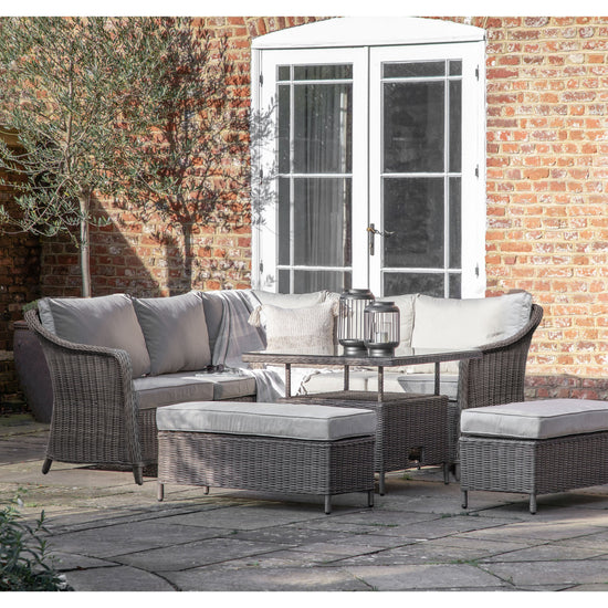 A McHale Square Dining Set With Rising Table Grey wicker home furniture set from Kikiathome.co.uk in a patio.