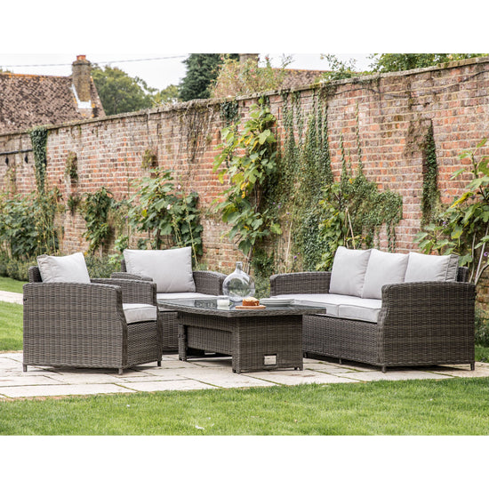 A Bigbury 5 Seater Dining Set with a Rising Table, perfect for interior decor in a garden.