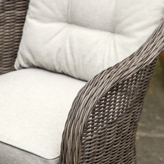A close up of a Meavy 2 Seater Bistro Set Natural outdoor wicker chair from Kikiathome.co.uk, perfect for home furniture or interior decor.