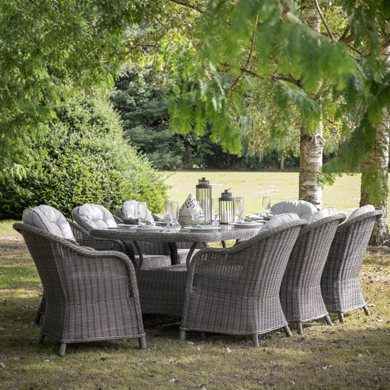 A Meavy 8 Seater Dining Set Grey by Kikiathome.co.uk, perfect for interior decor and home furniture, set up in a grassy area.