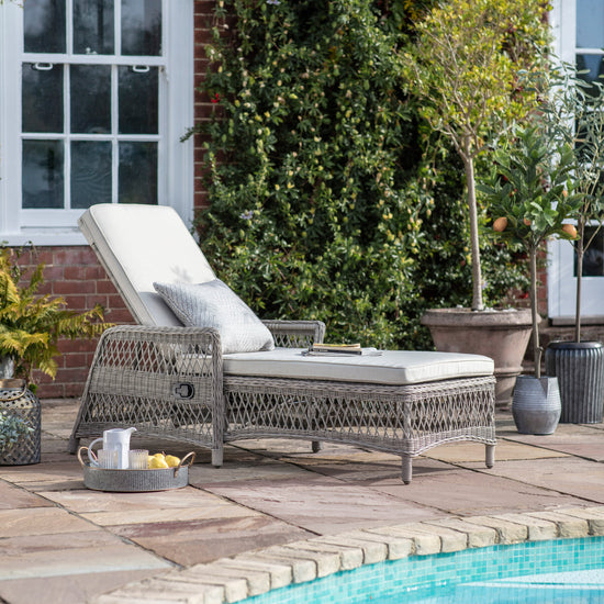 Load image into Gallery viewer, An Allington Country Lounger Stone by Kikiathome.co.uk, perfect for home furniture and interior decor, placed next to a pool.

