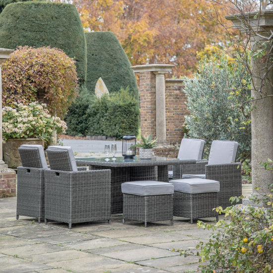 A Cadbury 8 Seater Cube Dining Set Grey by Kikiathome.co.uk as home furniture in a garden.