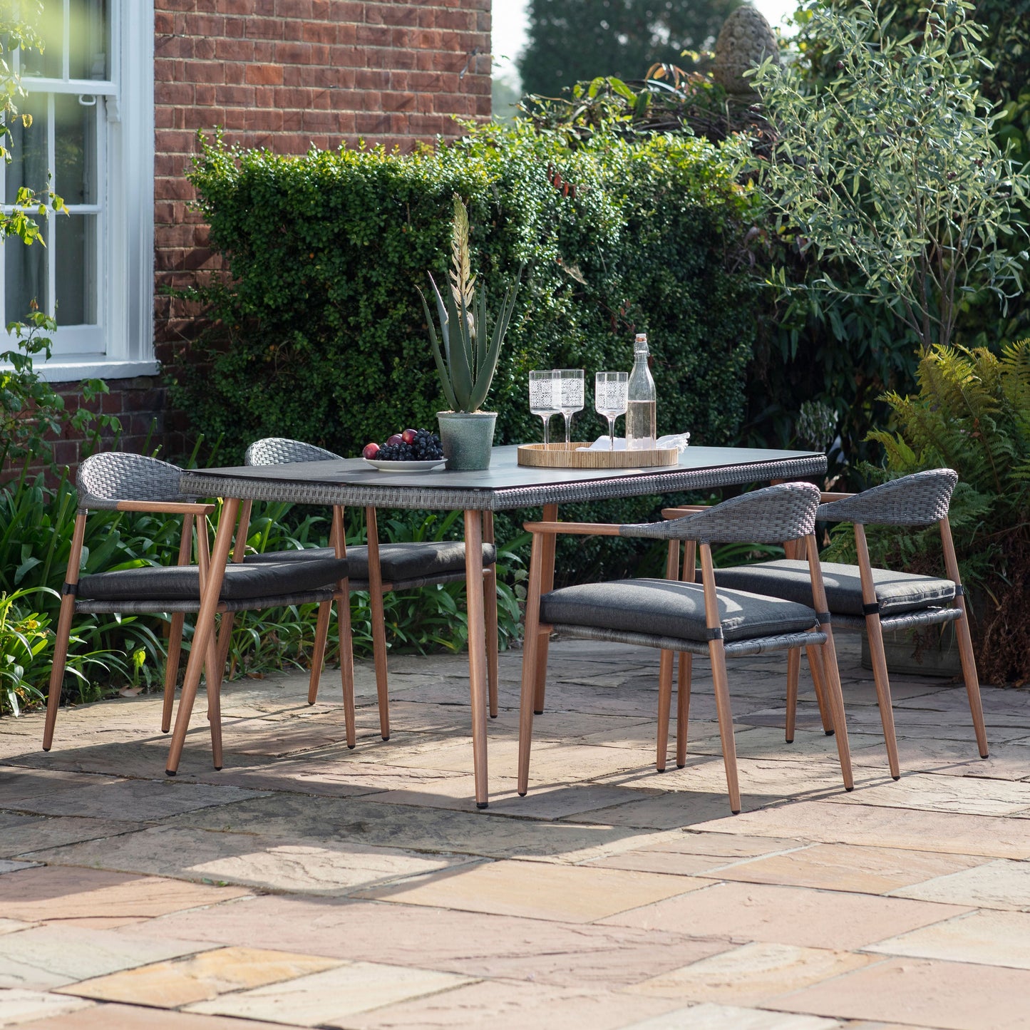 An Kilmington 4 Seater Dining Set by Kikiathome.co.uk that enhances the patio's interior decor with home furniture.