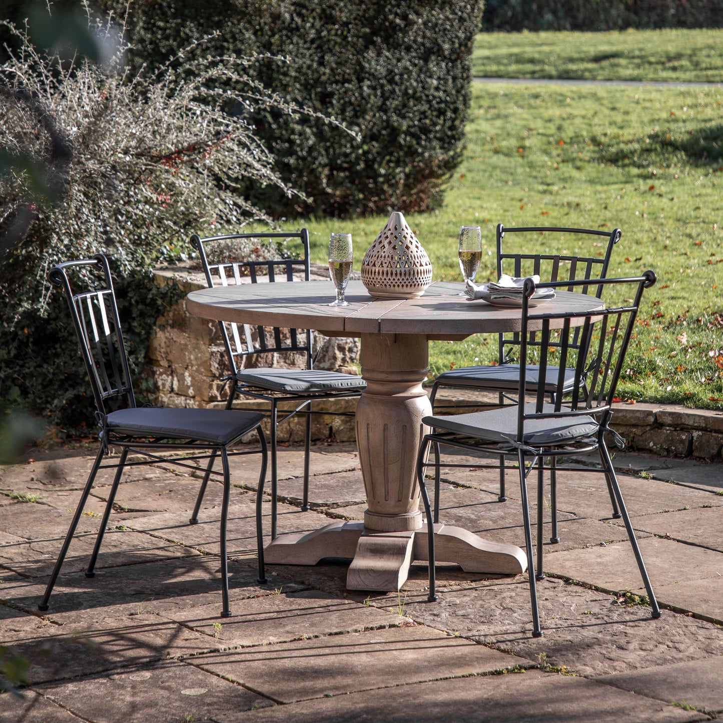 A Harberton Round Dining Table and chairs for interior decor from Kikiathome.co.uk.