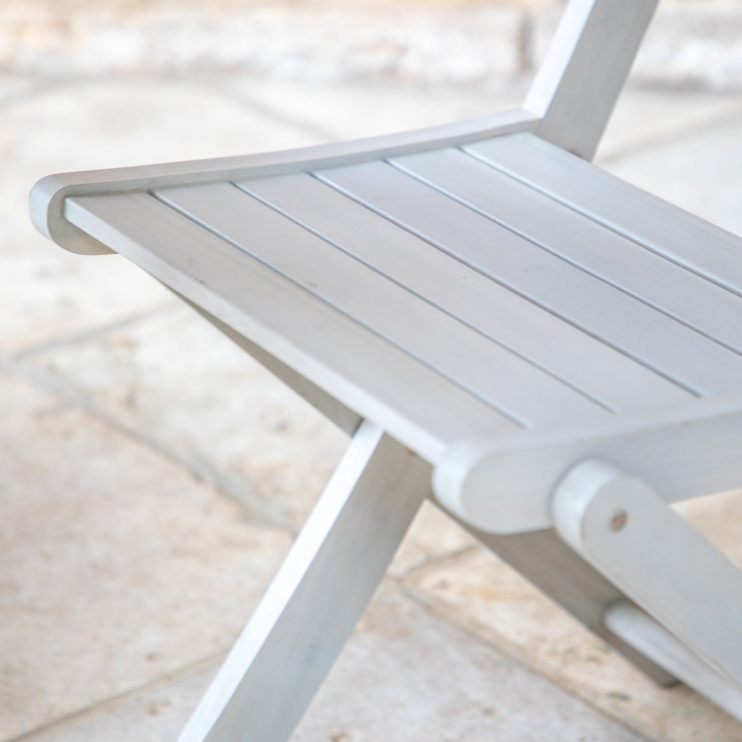 A close up of a Chillington 2 Seater Bistro Set Whitewash chair from Kikiathome.co.uk, perfect for home furniture.
