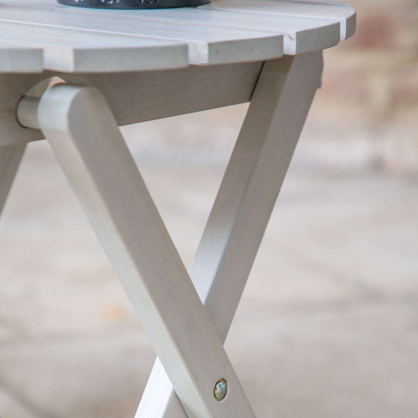 A Whitewash Side Table from Kikiathome.co.uk adorned with a vase, perfect for home furniture and interior decor.