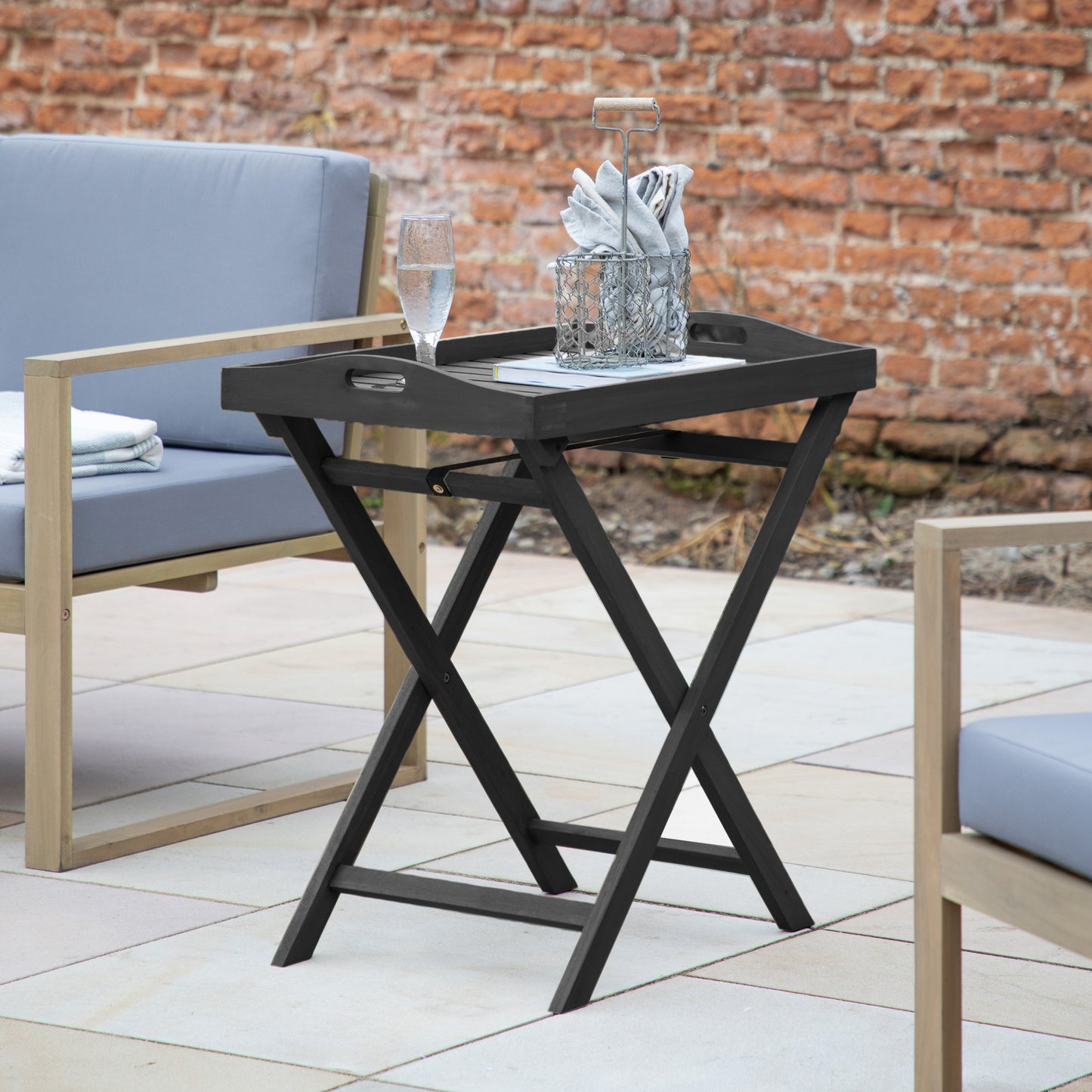 A patio with stylish Alfrington Tray Table Charcoal and chairs from Kikiathome.co.uk, perfect for enhancing your home's interior decor.