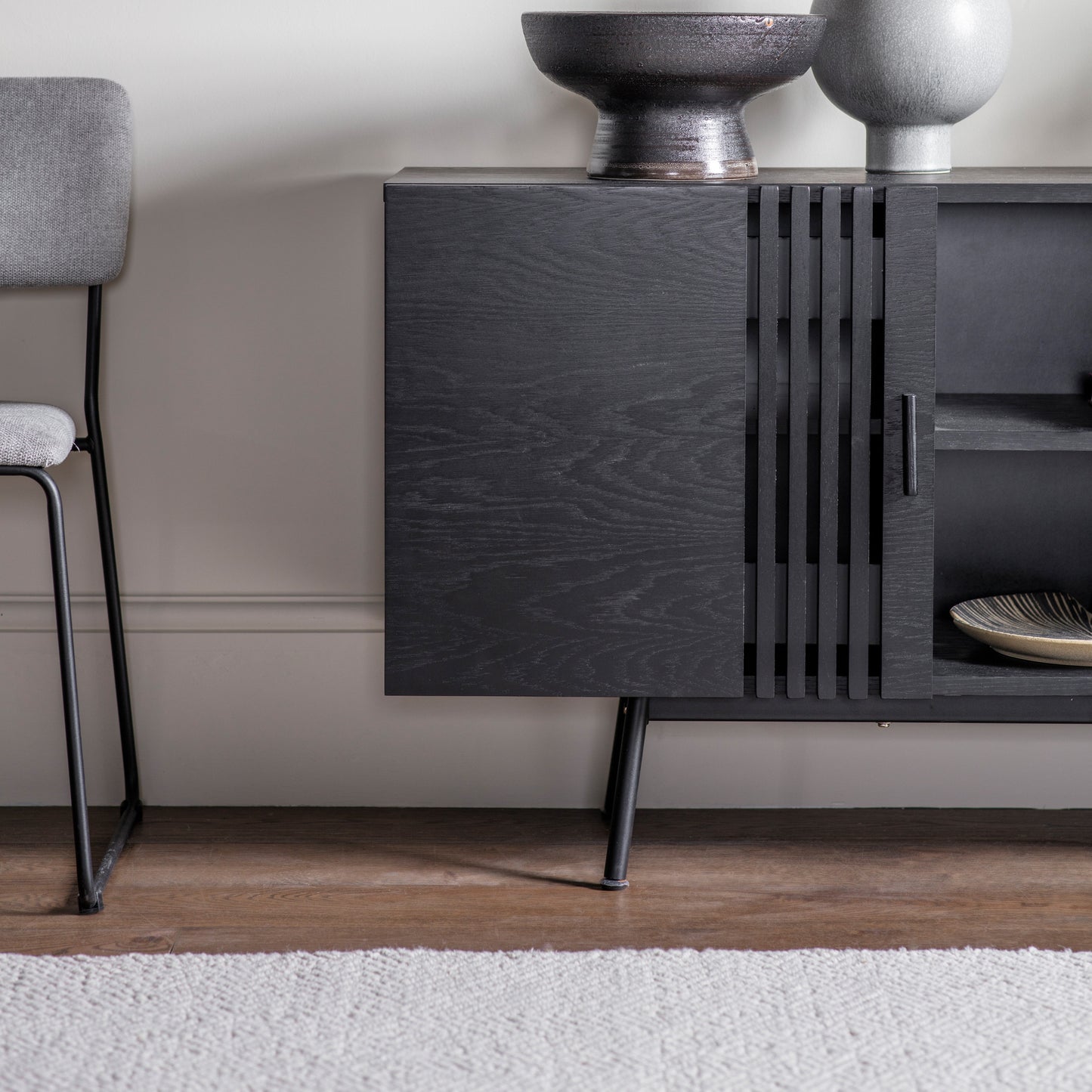 A Holston Sideboard and black chair, perfect for interior decor and home furniture.