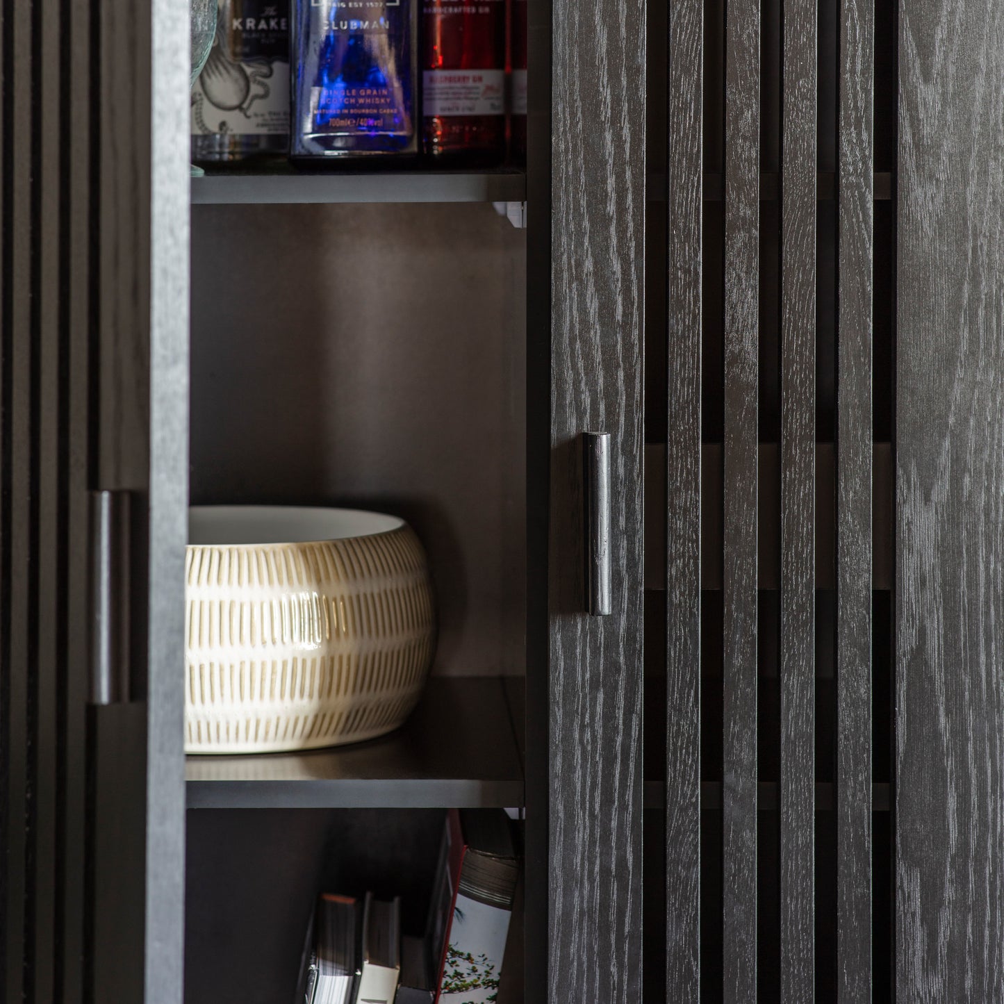 Load image into Gallery viewer, A black Holston drinks cabinet with shelves for interior decor.
