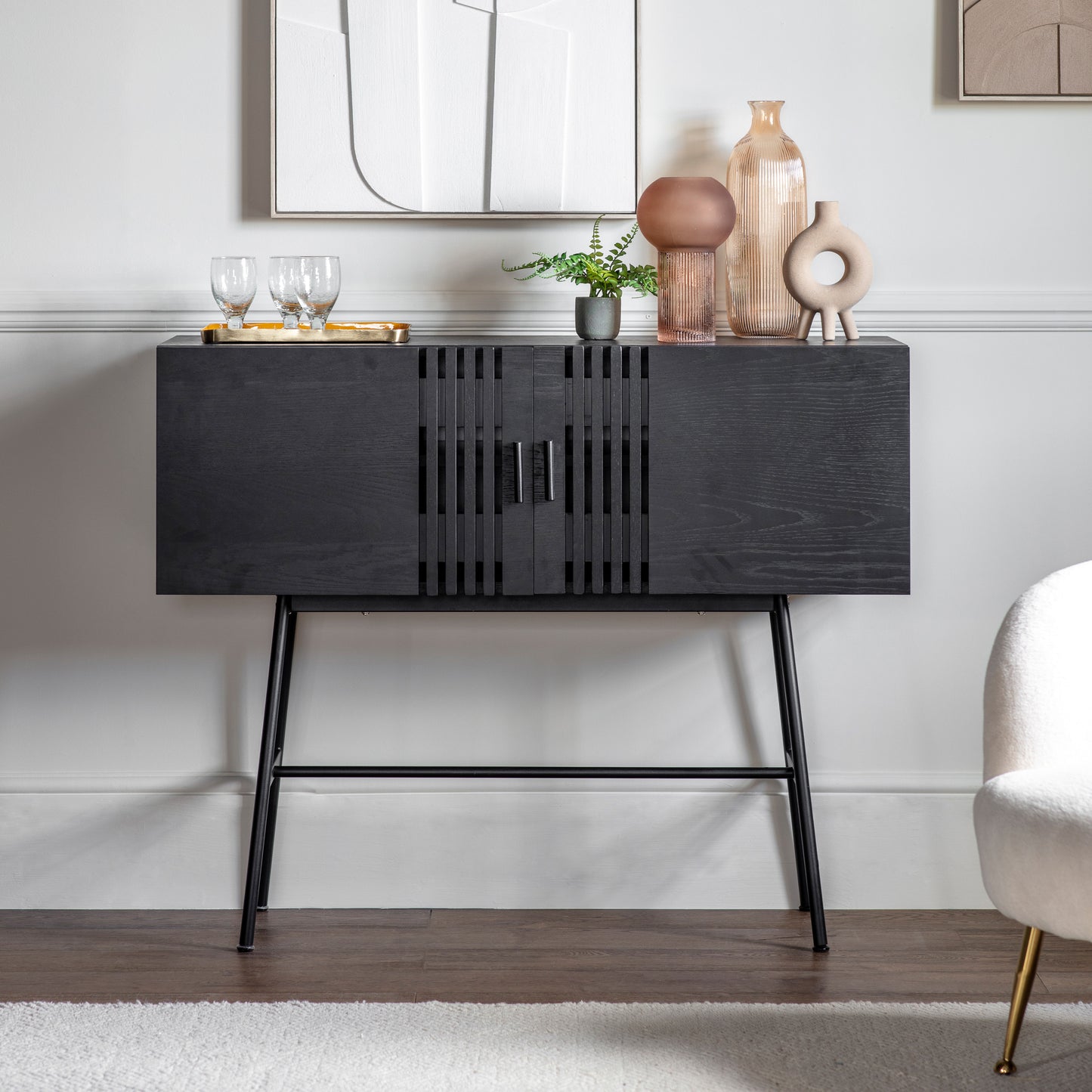A black Holston 2 Door Sideboard from Kikiathome.co.uk in a room with a chair and a vase, adding to the home furniture and interior decor.