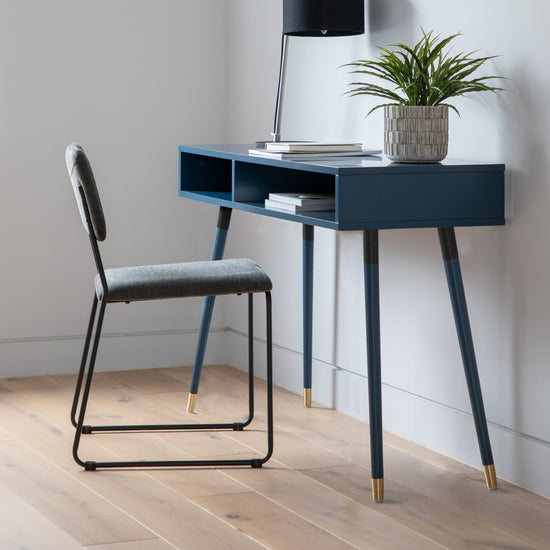 A Thurlestone Console Table Blue 1100x450x770mm by Kikiathome.co.uk adding elegance to home furniture and interior decor with a chair and a potted plant.