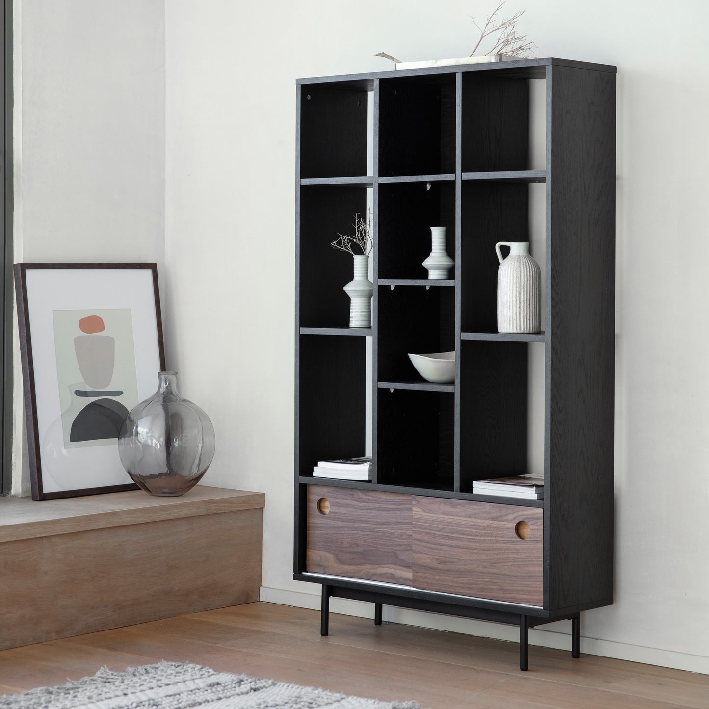 A Barbican Display Unit by Kikiathome.co.uk, part of the interior decor, is placed in a room with a vase.