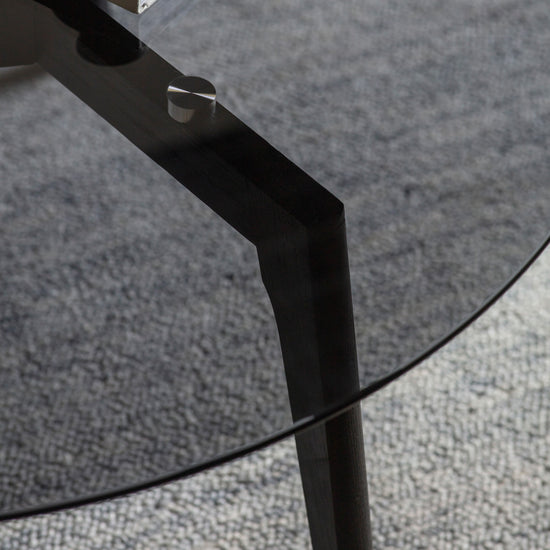 A close up of a Kikiathome.co.uk Ashprington Round Coffee Table in Black, adding style to interior decor.