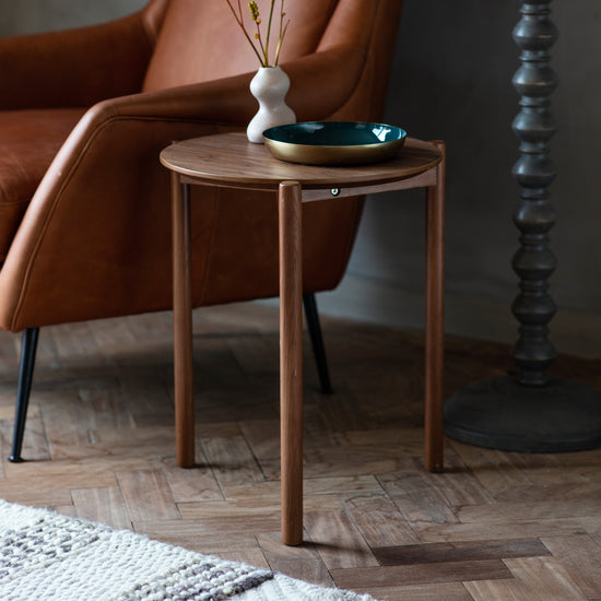 Interior decor with a Kikiathome.co.uk walnut side table and brown leather chair.