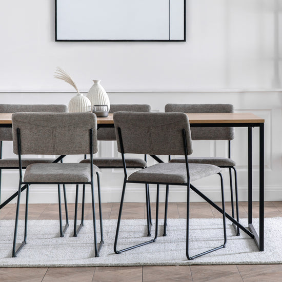 Load image into Gallery viewer, A Staverton Dining Table 1800x900x750mm with four chairs and a framed picture, ideal for interior decor or home furniture enthusiasts, from Kikiathome.co.uk.
