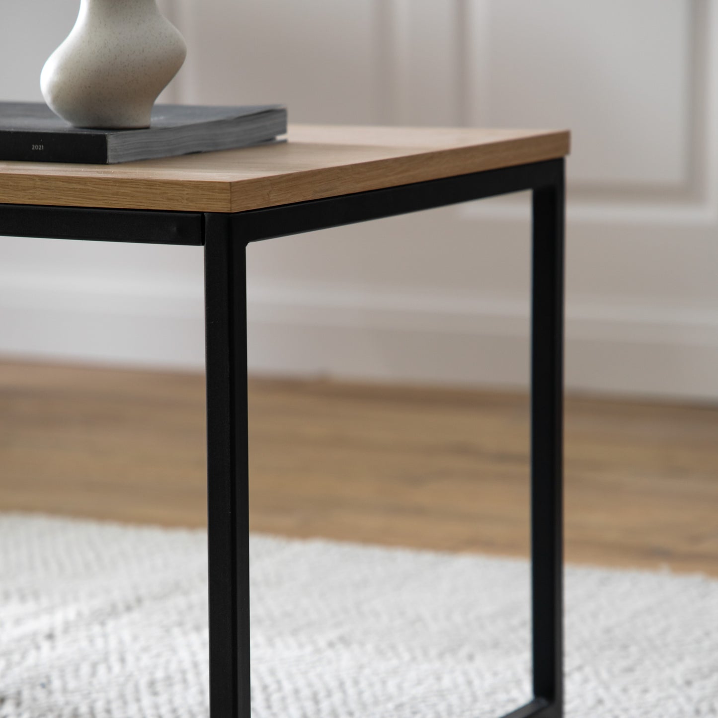 A Staverton Coffee Table 1000x500x450mm with a vase on top of it for interior decor and home furniture purposes.