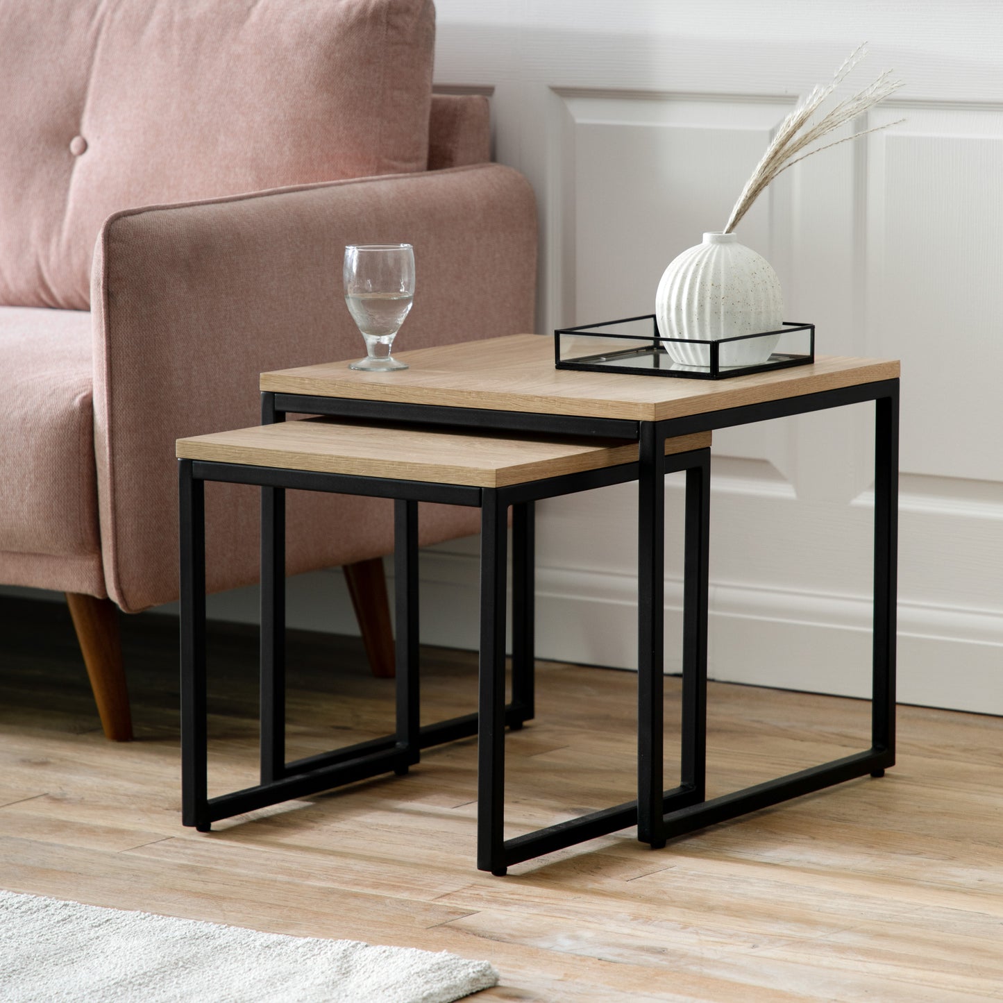 Two Staverton home furniture side tables from Kikiathome.co.uk in a room with a pink couch.
