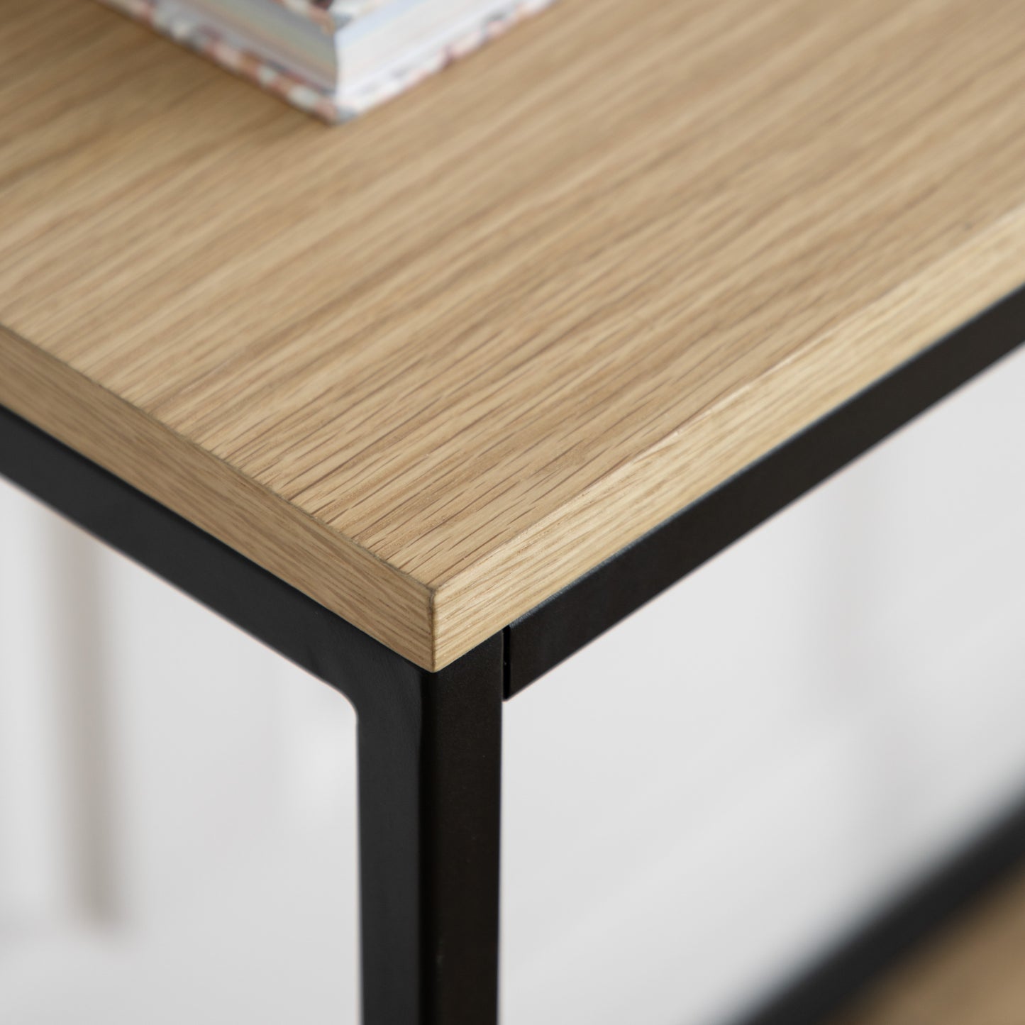 A close up of a Staverton Console Table 1000x380x750mm from Kikiathome.co.uk with a book on it, showcasing interior decor.