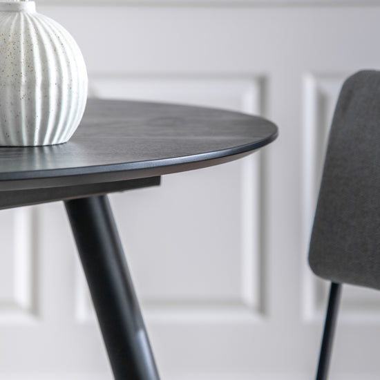 An Ashford Round Dining Table Black 900x900x750mm with a white vase, perfect for interior decor and home furniture.