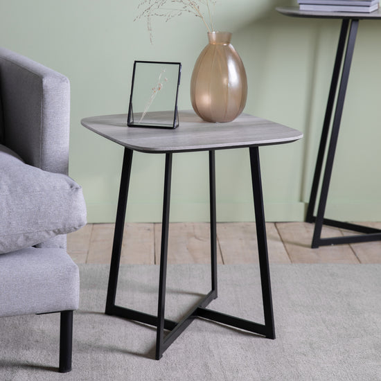 A stylish and modern Finsbury Side Table Oak Effect with a glass top, perfect for interior decor.
