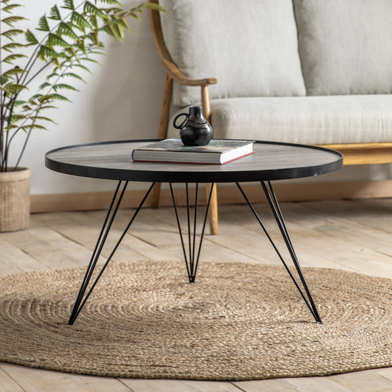 A Tufnell Coffee Table by Kikiathome.co.uk, perfect for home furniture and interior decor, placed on a rug in a living room.