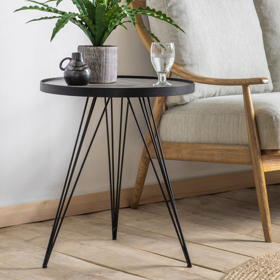 A Tufnell Side Table 500x500x560mm from Kikiathome.co.uk showcasing interior decor with a plant adornment.