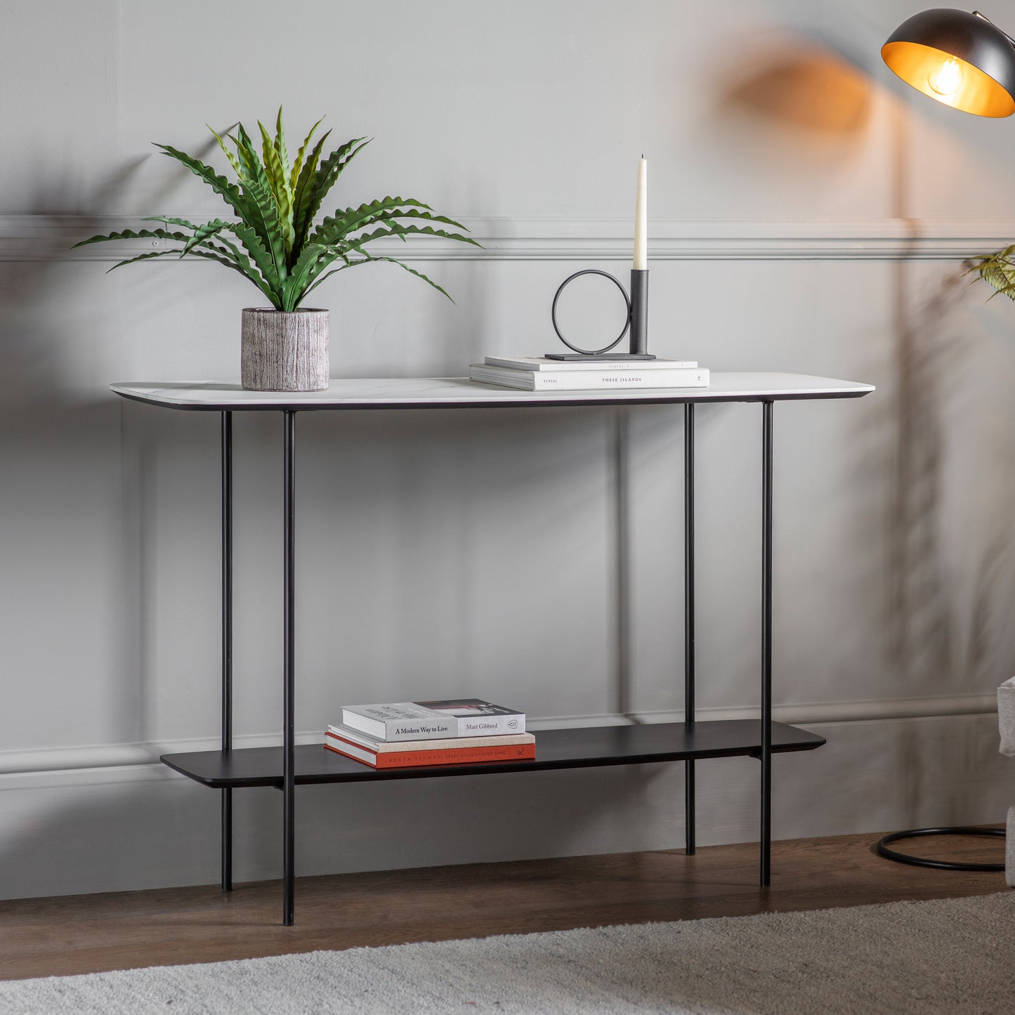 A Ludworth console table with a plant on top for interior decor purposes.
