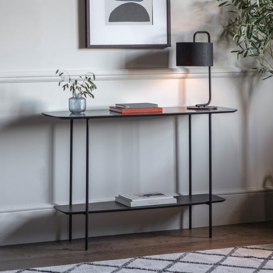 A Ludworth Console Table with a lamp, perfect for interior decor.