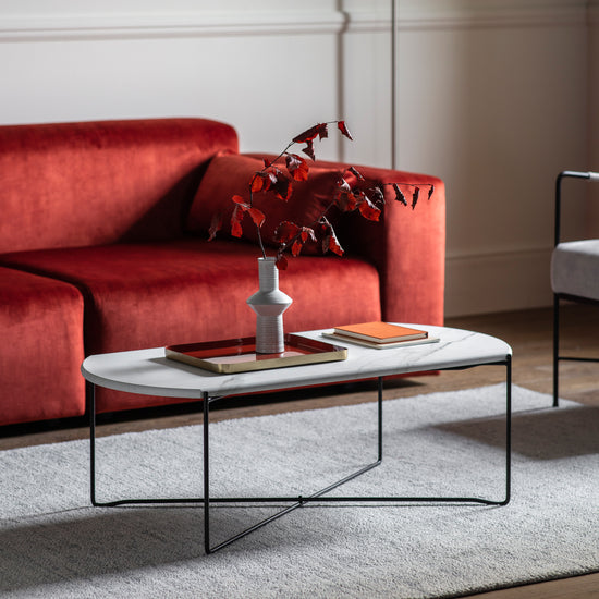 A stylish living room featuring a red couch and an elegant Kikiathome.co.uk Linford Coffee Table.
